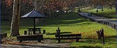 Park with picnic table, shelter, benches, and walking path.