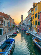 Venice canal, colorful buildings, boats, sunset sky