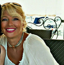 Helena smiling outdoors with boats in background. #aboutme