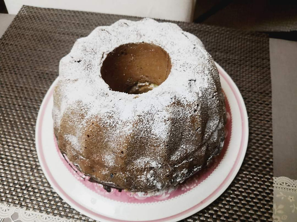 Kuglof-dessert-on-decorative-pink-plate-with-brown-coaster