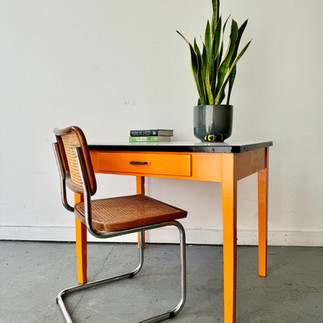 Orange desk with chair and plant; Home office; Creating a Timeless Vintage Inspired Home Office Aesthetic