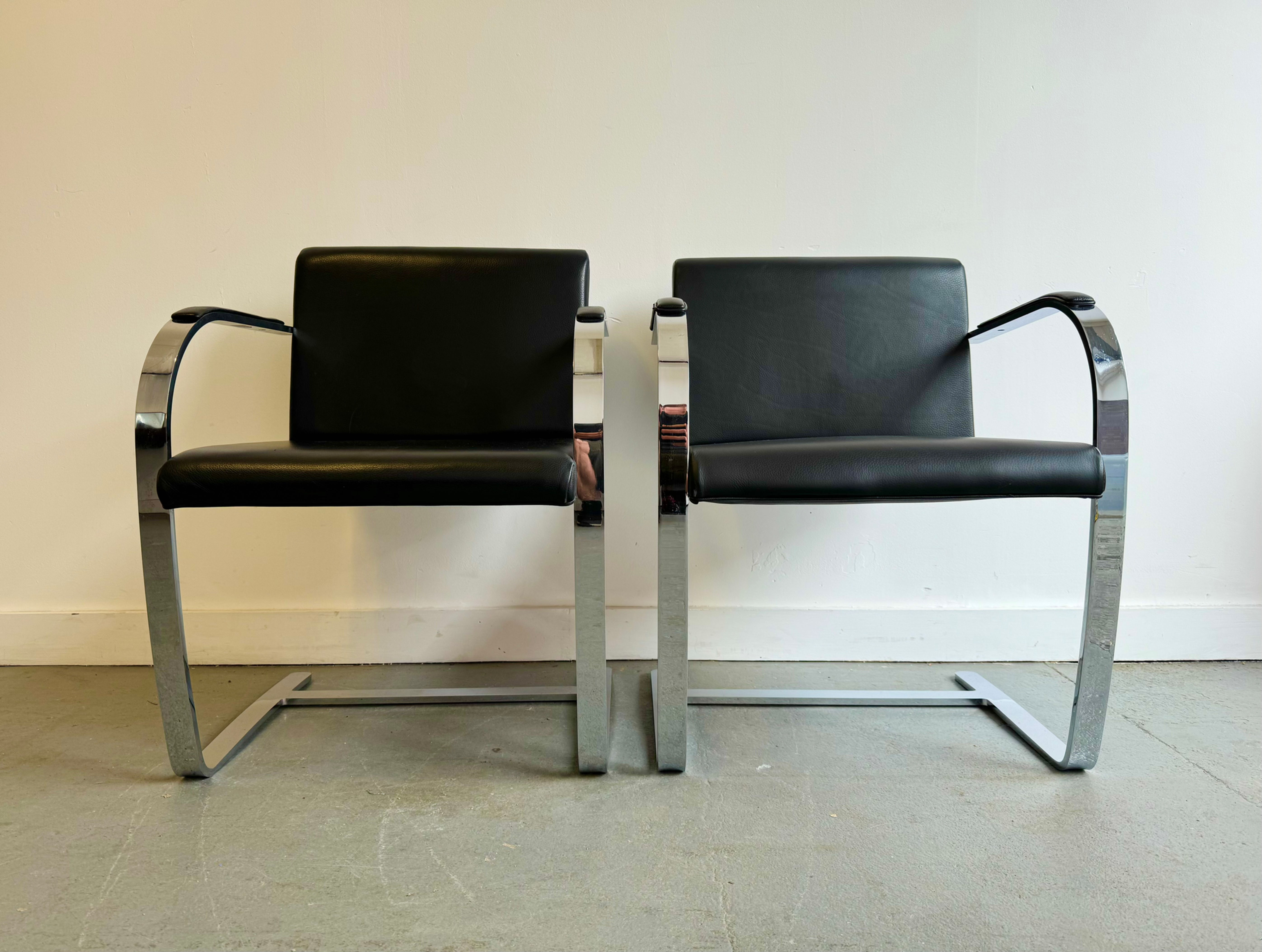 Pair of Black Vinyl Cantilever Side Chairs fronts