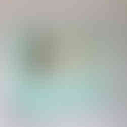 Elegant mirror with turquoise accents and a glass shelf, in bathroom.