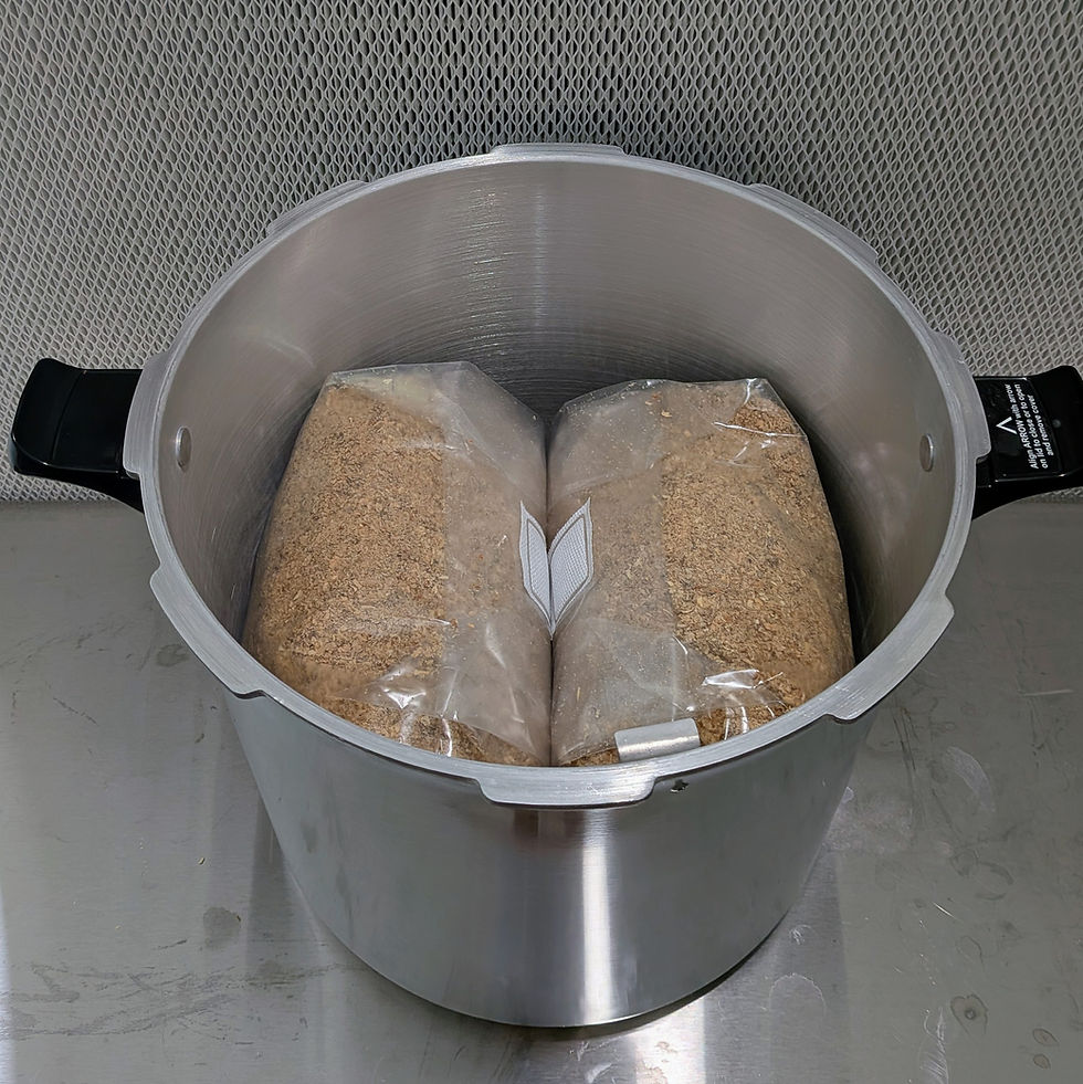 Stainless pot holds two sealed bags of grain on a metal counter, with black handles and small instruction text visible.