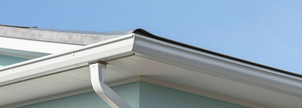 Hand removing debris from a gutter for resealing preparation.