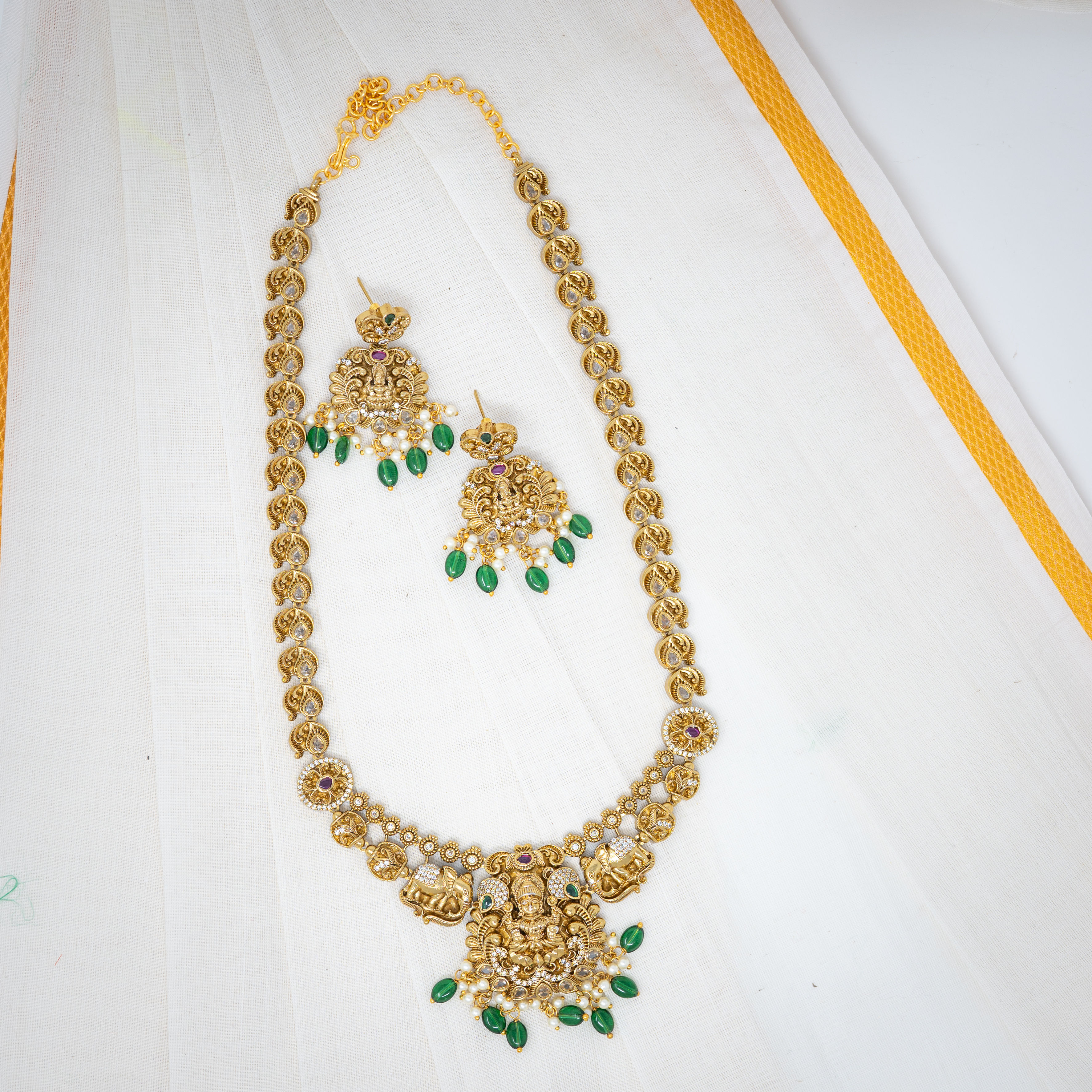 Regal Deity: Gold Necklace and Earring Set with Green and Pearl Highlights