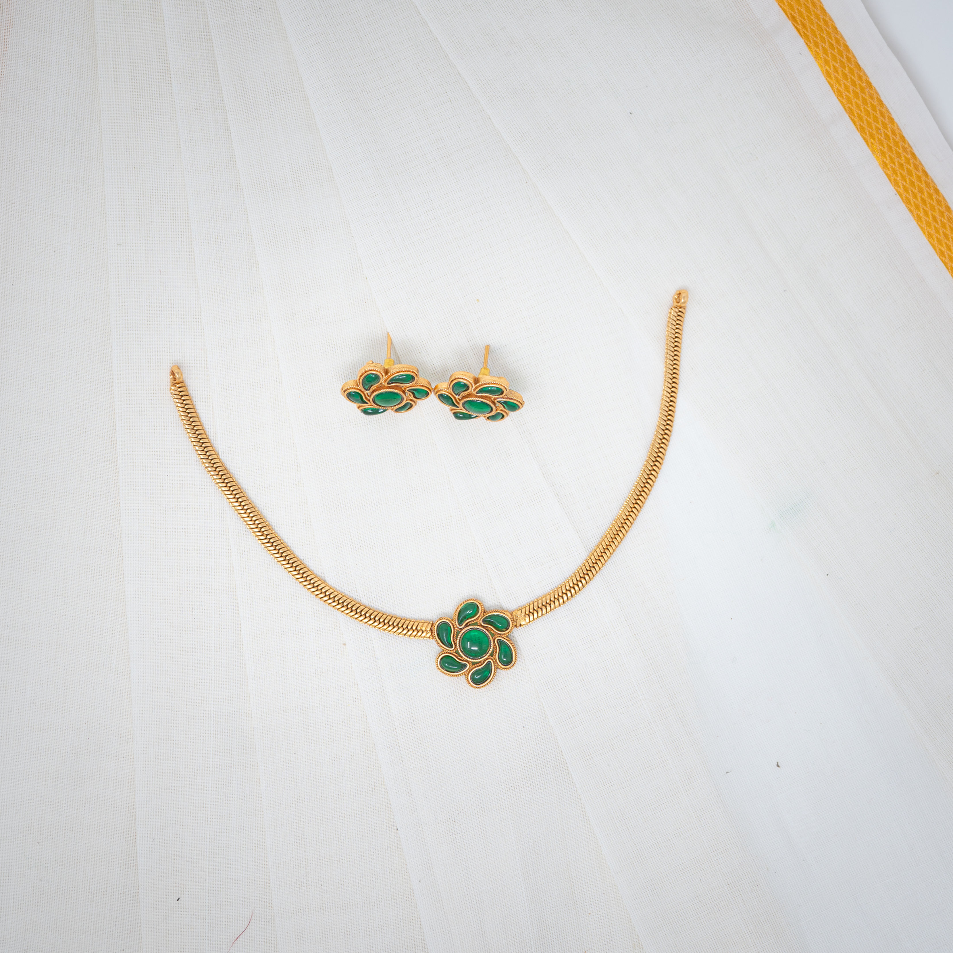 Emerald Elegance: Gold Floral Necklace and Earrings with Green Accents