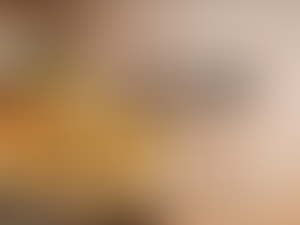 Creamy Tuscan gnocchi bake in a rustic ceramic dish with a golden, bubbly cheese topping, sun-dried tomatoes, and wilted spinach, garnished with fresh basil and set on a weathered wooden table with soft natural light.