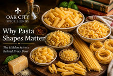 A collection of uncooked pasta shapes including spaghetti, rigatoni, farfalle, fusilli, shells, tagliatelle, and ditalini arranged in rustic bowls on a wooden table with Parmesan cheese, basil, and olive oil. The image features the title "Why Pasta Shapes Matter: The Hidden Science Behind Every Bowl"