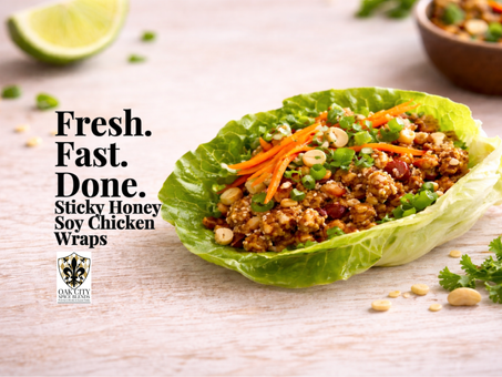 A single chicken lettuce wrap filled with glossy honey soy ground chicken, topped with shredded carrots, green onions, and crushed peanuts, sits on a wooden surface with soft light and open space on the right.