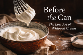 Close-up of whipped cream at three stages in a rustic metal bowl: soft and loose, perfect soft peaks, and overwhipped cream beginning to separate into butter, demonstrating how to properly whip cream.