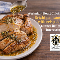 Golden home-roasted chicken with crispy skin, sliced and served on an oval platter with a lemon and fresh herb tarragon pan sauce, styled on a rustic wooden table with soft natural light.