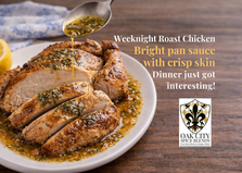 Golden home-roasted chicken with crispy skin, sliced and served on an oval platter with a lemon and fresh herb tarragon pan sauce, styled on a rustic wooden table with soft natural light.