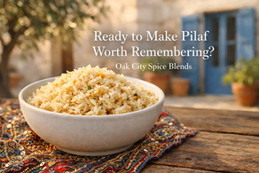 Fluffy long-grain rice pilaf with lightly toasted golden grains and diced onion in a simple ceramic bowl on a rustic wooden table. A sparkling embroidered Mediterranean linen sits beneath the bowl, with a soft-focus courtyard background featuring cream stone walls, blue shutters, and olive tree shadows. Text overlay reads, “Ready to Make Pilaf Worth Remembering? Oak City Spice Blends.”