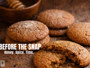 Warm, rustic spice cookies on a wooden surface with one broken open to show a soft interior, styled with a honey dipper and natural light.