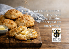 reshly baked drop biscuits topped with Everything Biscuit seasoning, shown on a rustic wooden board with one biscuit split open and butter melting inside, while seasoning is lightly sprinkled from above.