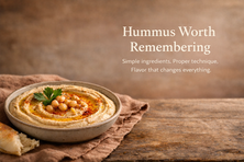 Creamy hummus in a rustic ceramic bowl swirled with olive oil and topped with paprika, chickpeas, and parsley, served with torn pita on a wooden table, with bold editorial text reading “Hummus Worth Remembering.”