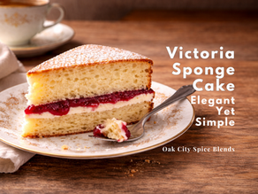 Slice of traditional Victoria sponge cake with raspberry jam filling and powdered sugar served on a floral plate with tea, photographed with open table space for text.