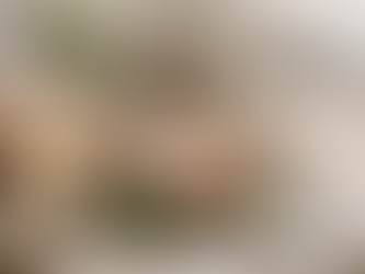 A rustic Easter table set in soft natural light with a linen cloth, fresh eggs in a wooden bowl, sliced artisan bread, butter, herbs, and simple spring flowers, styled in a calm farmhouse setting with space on the right.