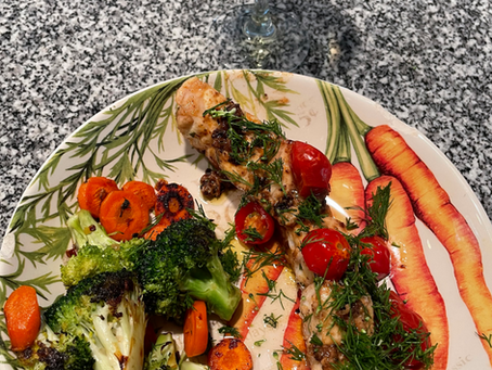 Fresh grouper with herbs & cherry tomato along side broccoli and carrots seared in cast iron skillet