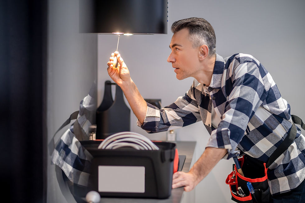 renovation-profile-concentrated-man-touching-screwdriver-lamp-kitchen-range-hood.jpg