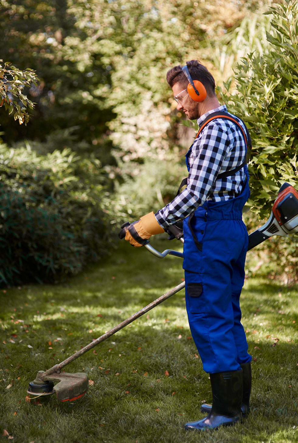 busy-man-using-weedwacker-garden.jpg