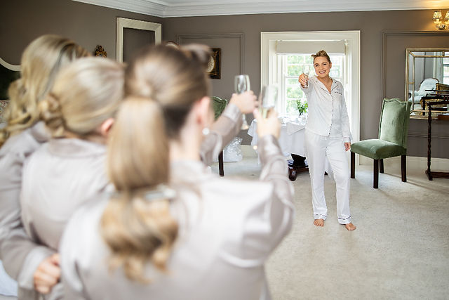 Close-up of a bride’s final touches before walking down the aisle.