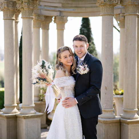 Wedding couple posing in front of the Victorian house at Killashee Hotel for their portrait photos.