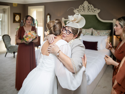 Bride and her mother sharing a heartfelt hug at Clonabreany House.
