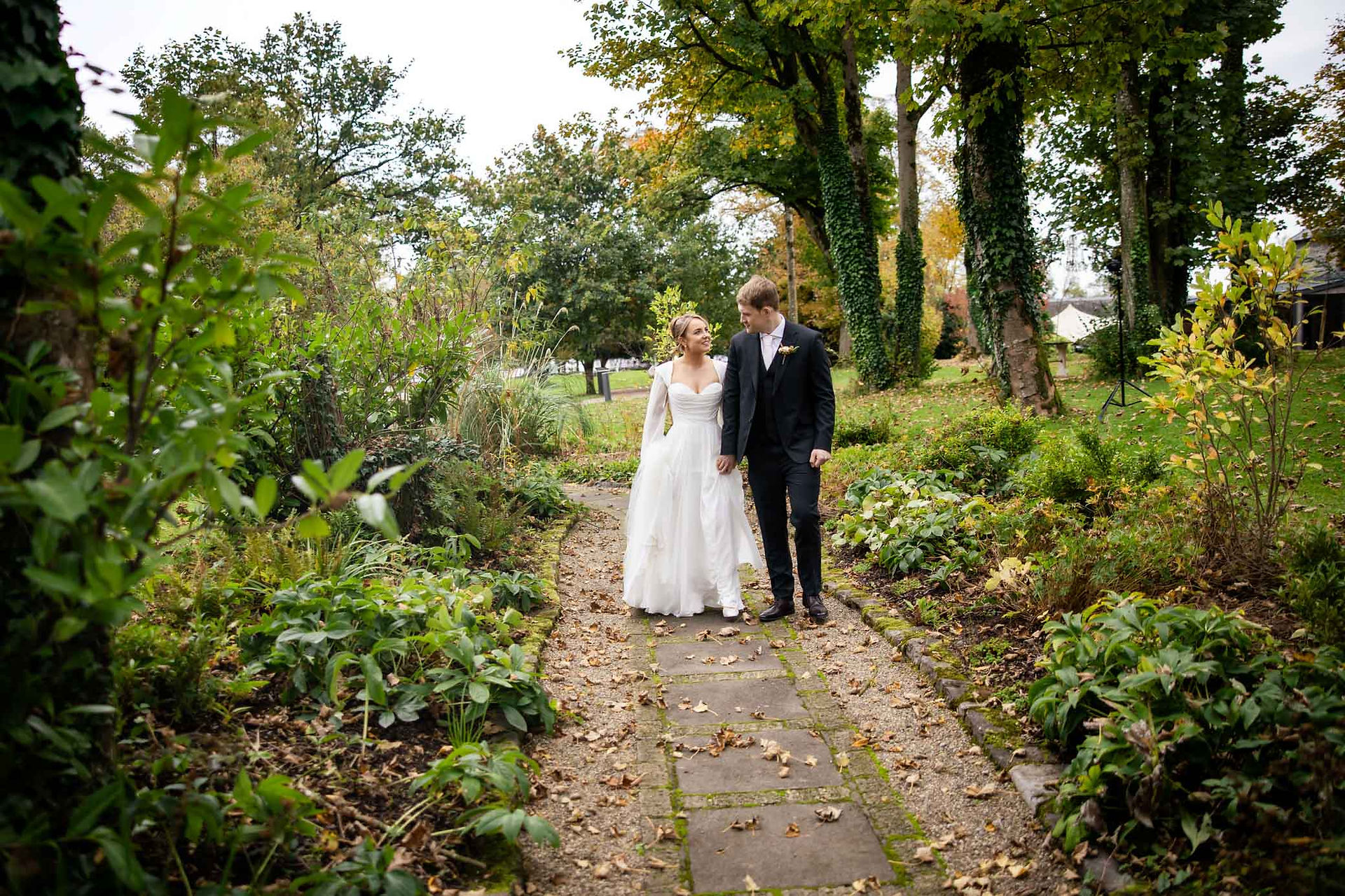 Natural and relaxed photo of a bride and groom laughing together at their wedding.