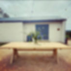 a large garden table in front of a modern building