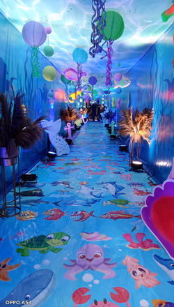 Grand wedding decor in royal blue with velvet drapes, gold accents, and floral arrangements for a lu