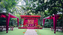 Luxury engagement stage decoration in Bangalore with red floral backdrop and elegant outdo