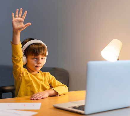 school-boy-yellow-shirt-taking-virtual-classes-raising-hand (1).jpg