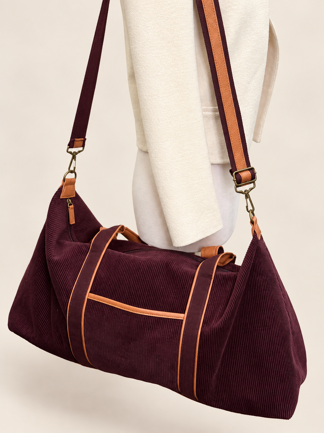 DSW burgundy corduroy duffle bag with cognac-tone trim and shoulder strap
