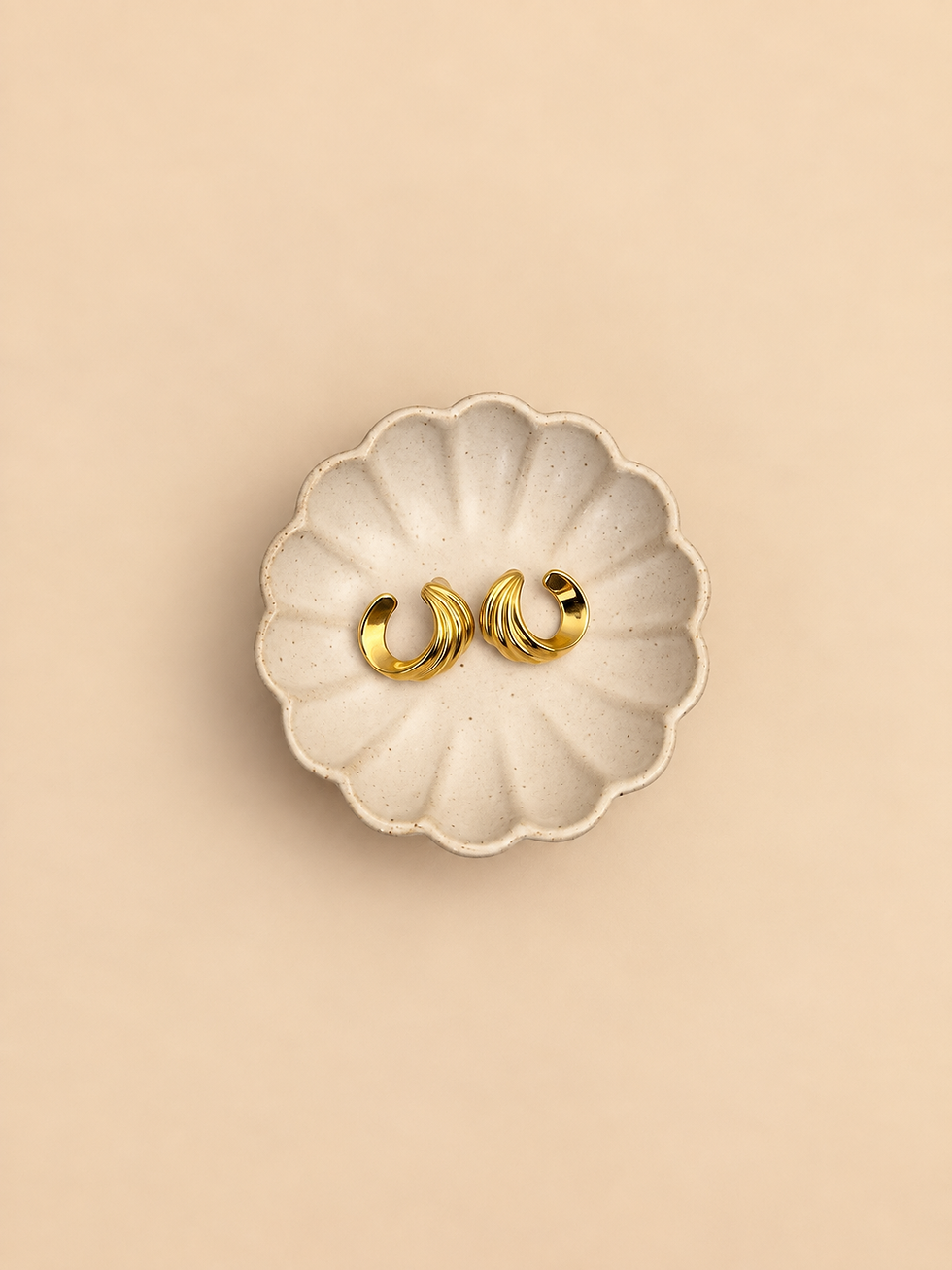Gold-tone sculptural swirl hoop stud earrings front view