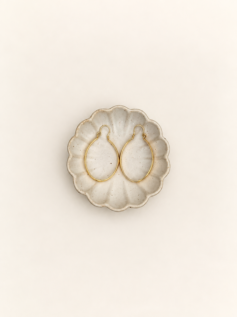 Gold-tone oval hoop earrings front view