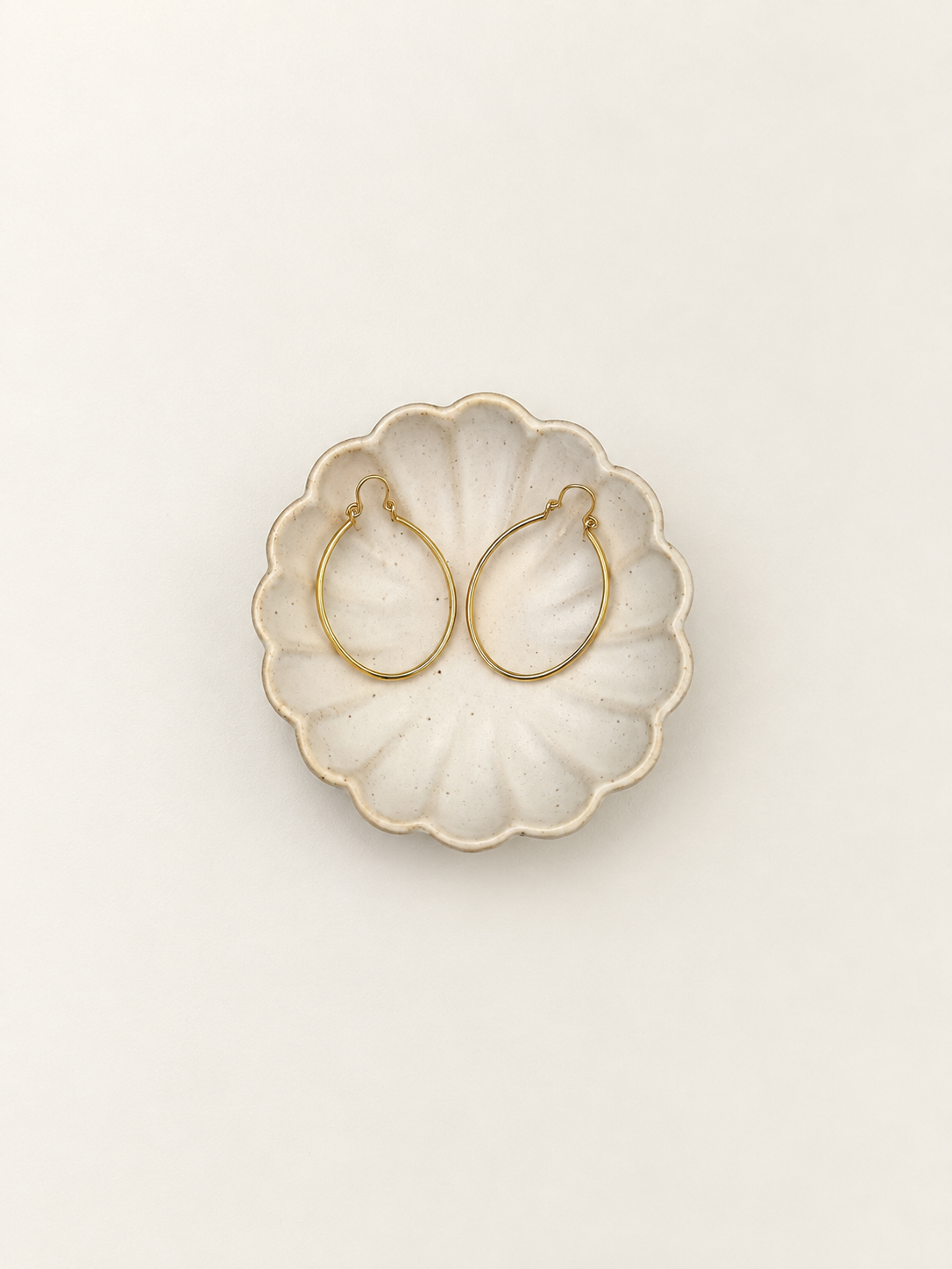 Gold-tone oval hoop earrings closure and back detail