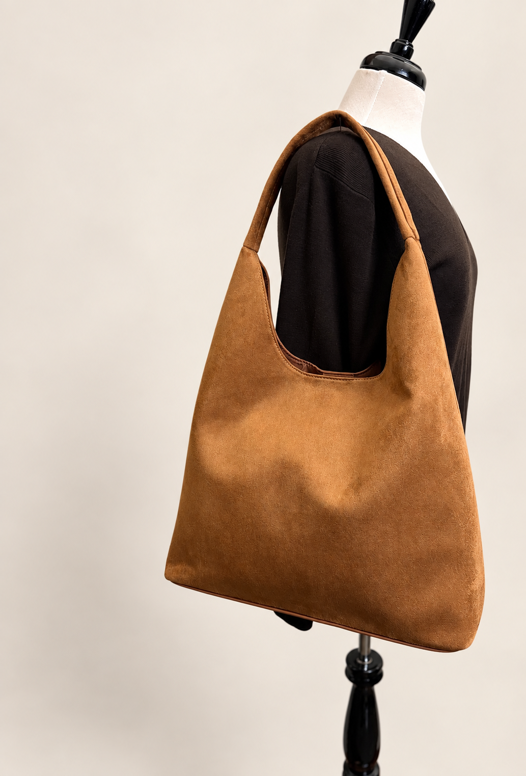 Crossi New York cognac suede hobo bag side view showing relaxed slouchy silhouette