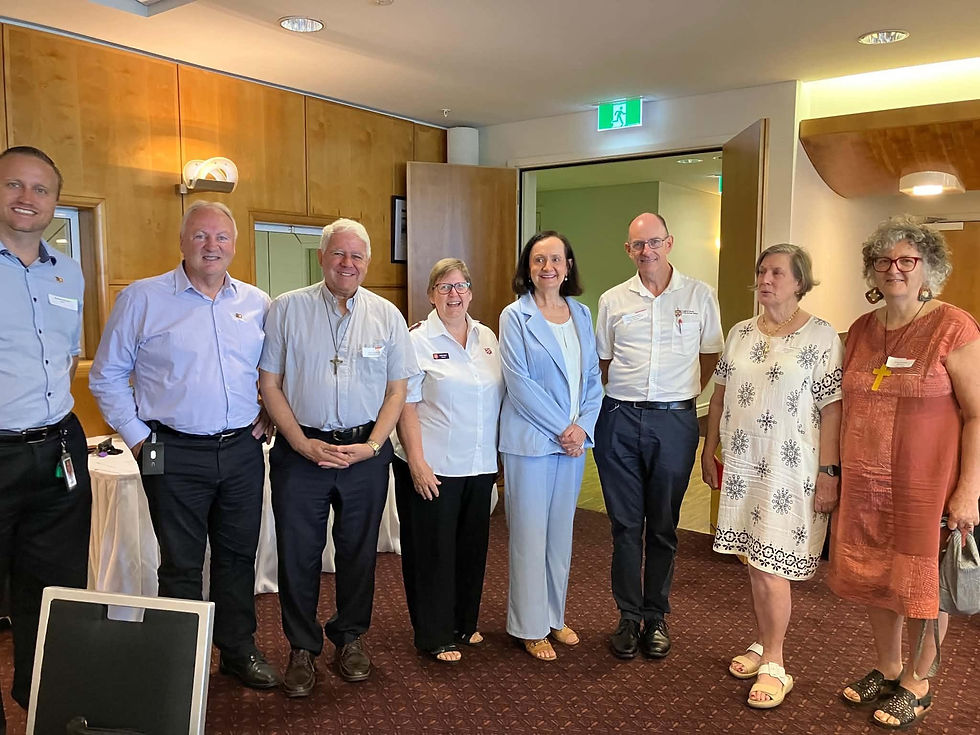 Faith representatives including Major Kaye Viney (centre), standing alongside Robyn Lambley at the event. Image: Facebook