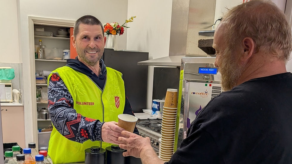 A Salvos volunteer serves up a hot cuppa to a winter night shelter guest in Bendigo. Image: Supplied