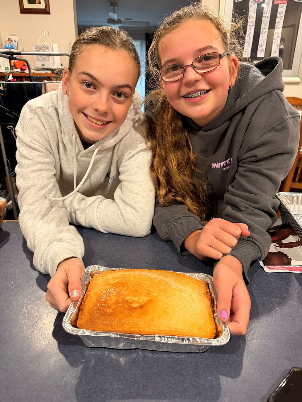 Amelie and Paige with a baked cake. Image: Supplied