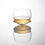 A rocking whiskey glass made from clear coloured crystal with whiskey
