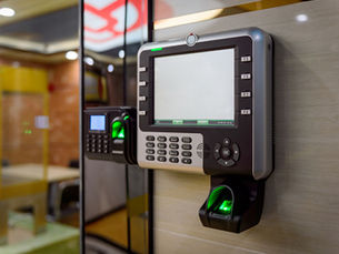 Commercial door fitted with a modern electronic access control keypad
