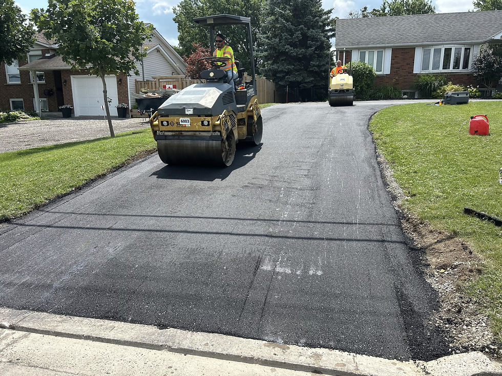 Freshly paved asphalt driveway with roller on it