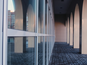 Commercial storefront glass wall viewed from inside a Hamilton business