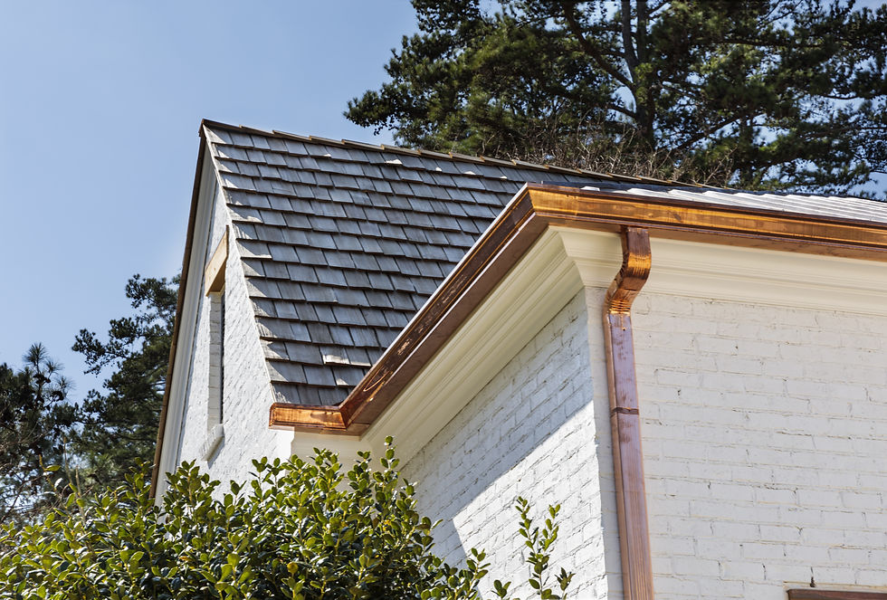 Beautiful new copper gutters installed on a white house.