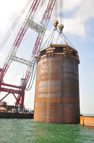 Array of 8 vibratory pile drivers.