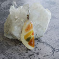 Handcrafted one-of-a-kind fused glass pendant in opalescent cream with sedimentary hues of amber, gold and green with a nickel bail.