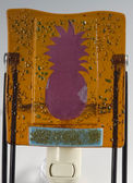 Handcrafted one-of-a-kind fused glass amber & green night light with copper foil inclusion cut into pineapple shape.